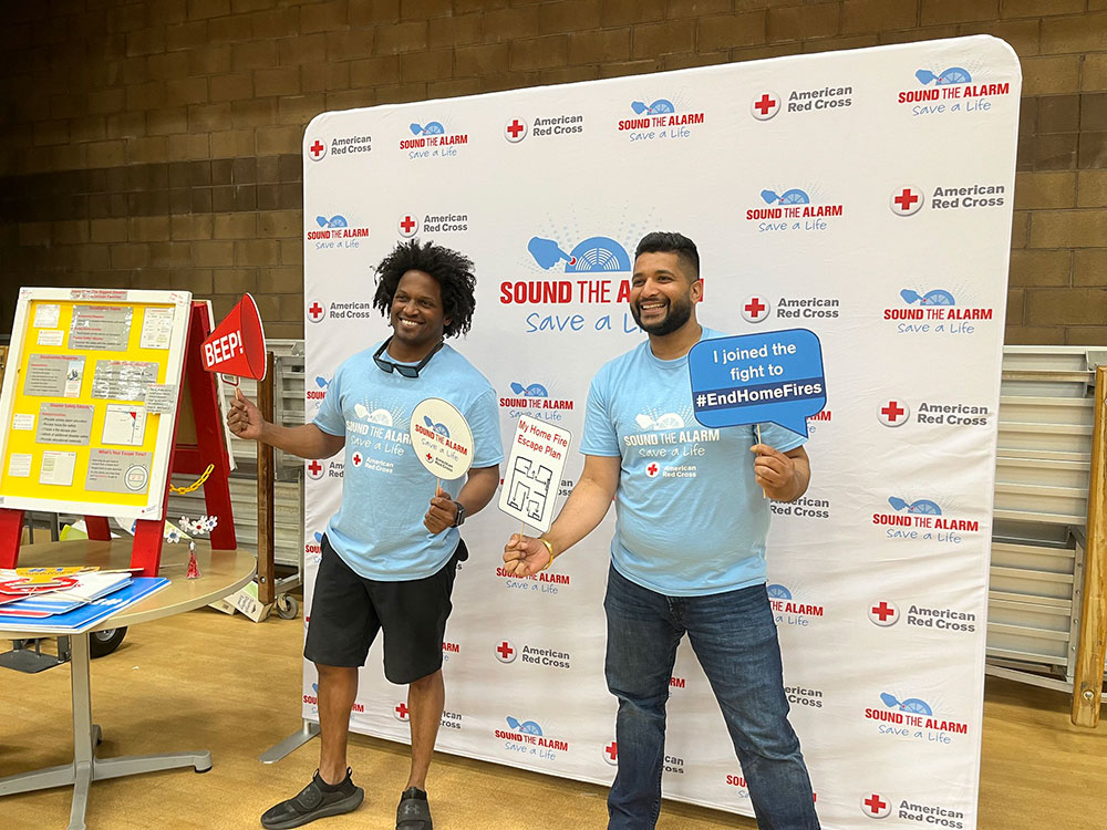 Gerald Golstein and another Red Cross volunteer promote sound the alarm at a Red Cross booth.