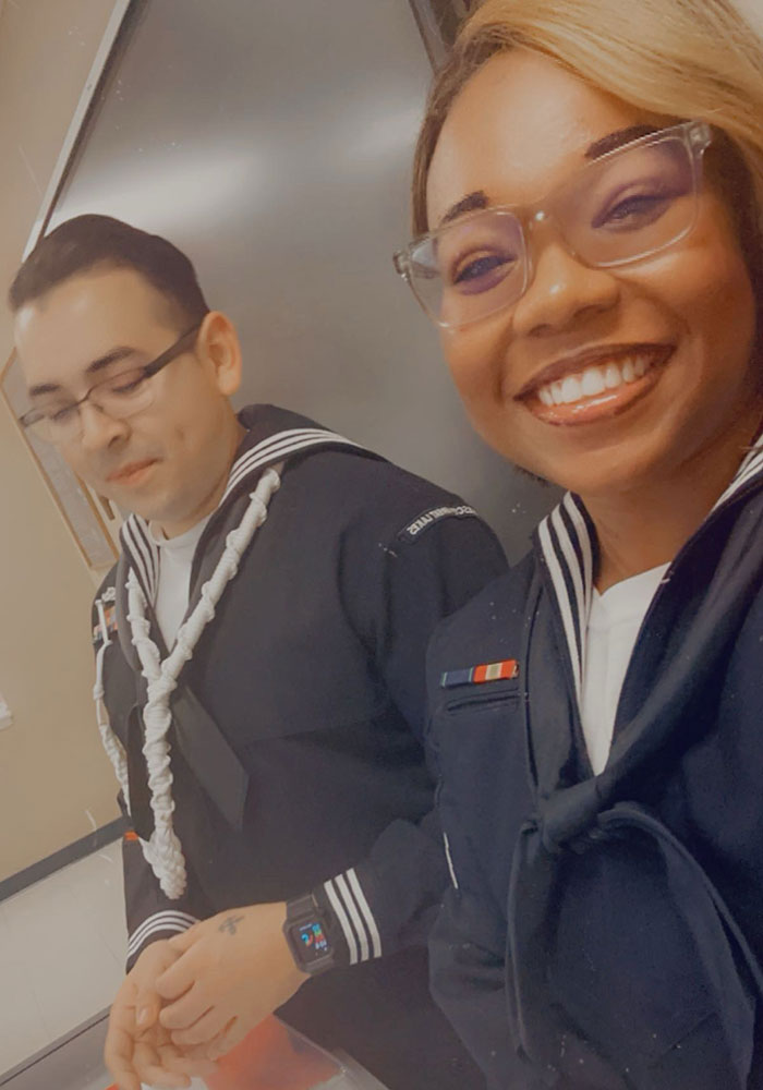 two people in navy outfits.