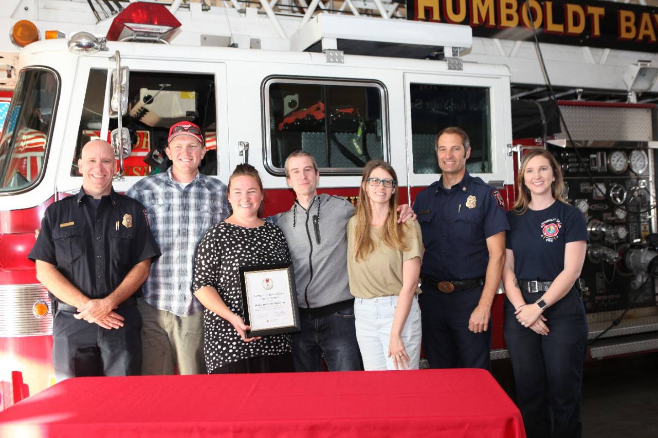Certificate for Extraordinary  Personal Action presented by Battalion Chief Tim Citro. Bruno and Carissa were in their house and unaware of fire coming out of the roof when Alex and Holly drove by. Holly jumped out of the car, banged on the door and called 911.