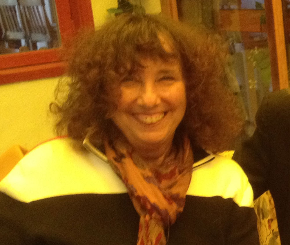 Jill Hofmann wearing scarf and smiling for camera.