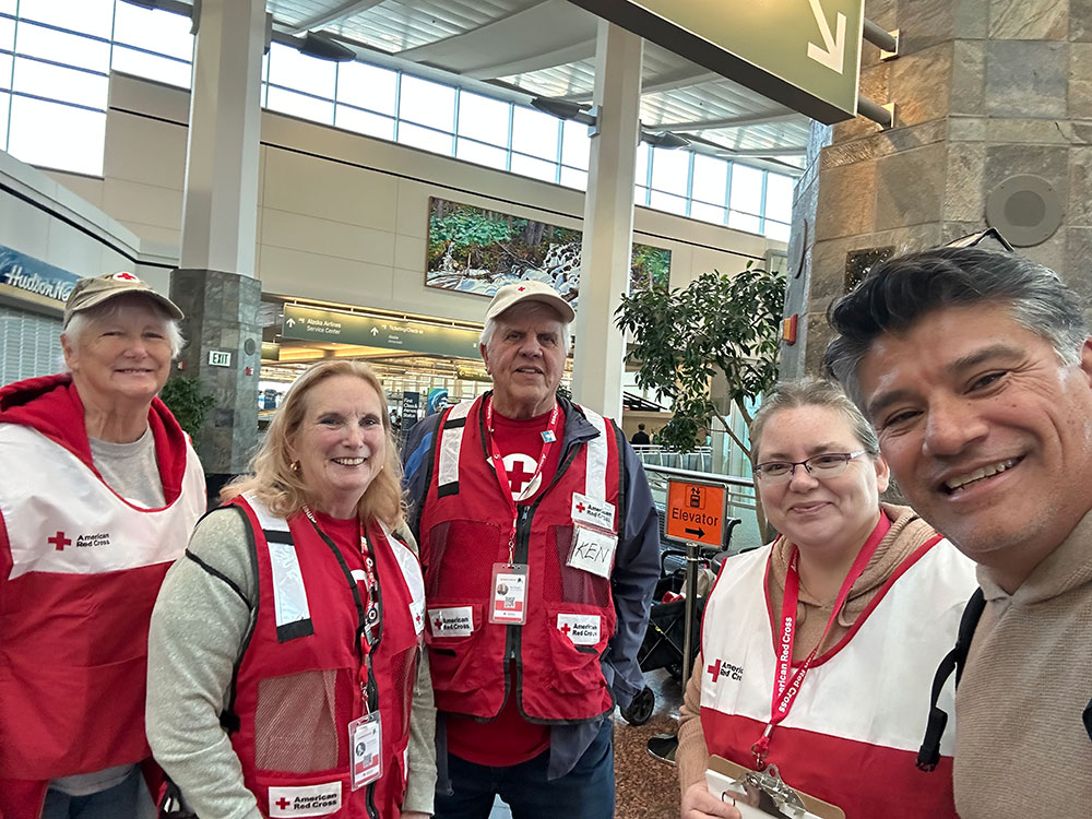 John Ruiz is received by the Red Cross welcome committee at the Ted Stevens Anchorage International Airport.