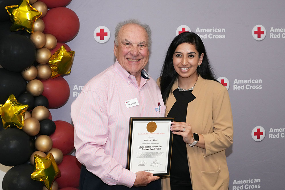 Colonel (Retired) Larry Dietz, US Army receiving his 2024 Clara Barton Leadership Award from Communications director Pooja Klebig.