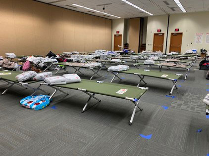 inside the anchorage red cross shelter with cots and blankets.