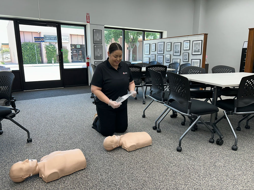 Margarita Moreno practicing CPR on a manikin.