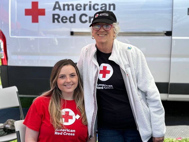 Red Crossers Sophie Rebecca and Eleanor Najjar greet Fleet Week visitors