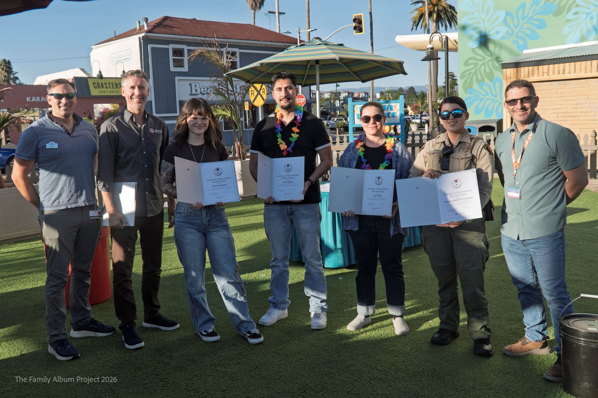 A group of people with awards at the Santa Cruz Boardwalk.