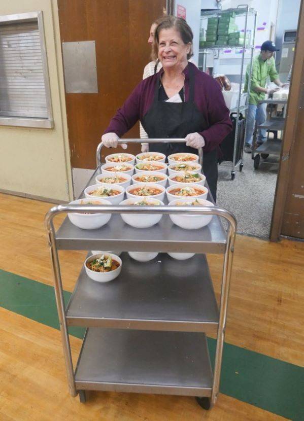 Red Cross volunteer pushing cart