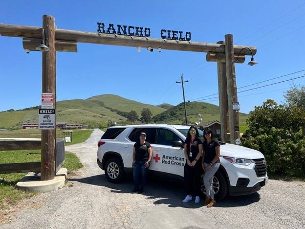 The CAP team in front the Rancho Cielo campus sign.