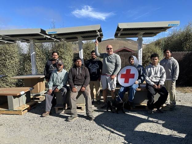 Rancho Cielo members sitting with the new workstations.