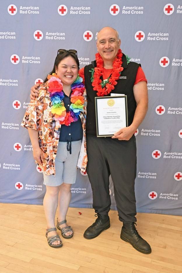 Aaron Teixeira (right) receiving his award from Sr. Community Disaster Program manager, Debbie Yee (left)