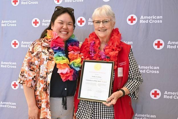 Kathy Lenihan (right) receiving his award from Sr. Community Disaster Program manager, Debbie Yee (left)