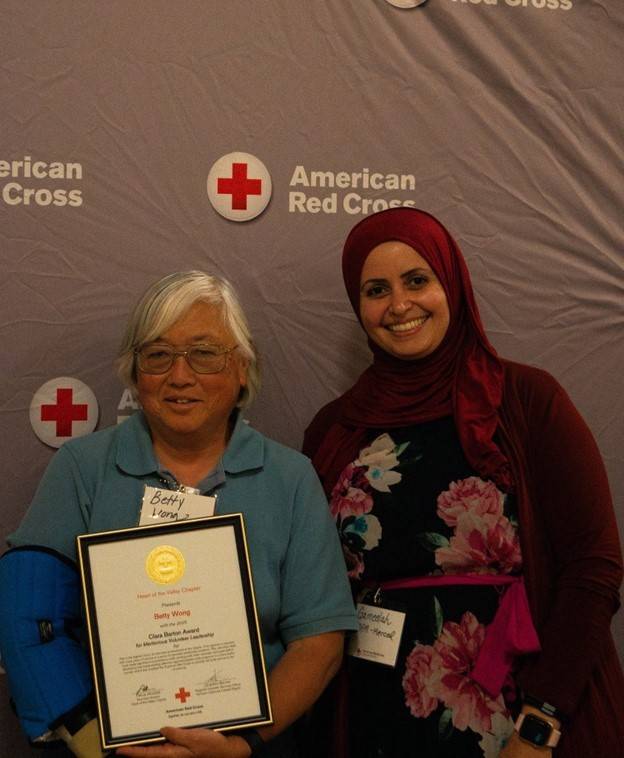 Betty Wong (left) receiving her award from Merced County Community Disaster Program manager, Gameelah Mohamed (right)