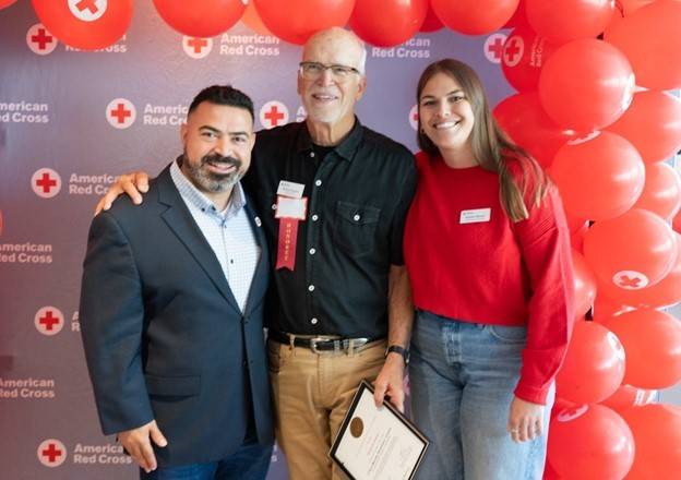 Richard Osicka (middle) receiving his award from Regional CEO, Hanna Malak (left), and Regional Mass Care manager, Natalie Manier (right)