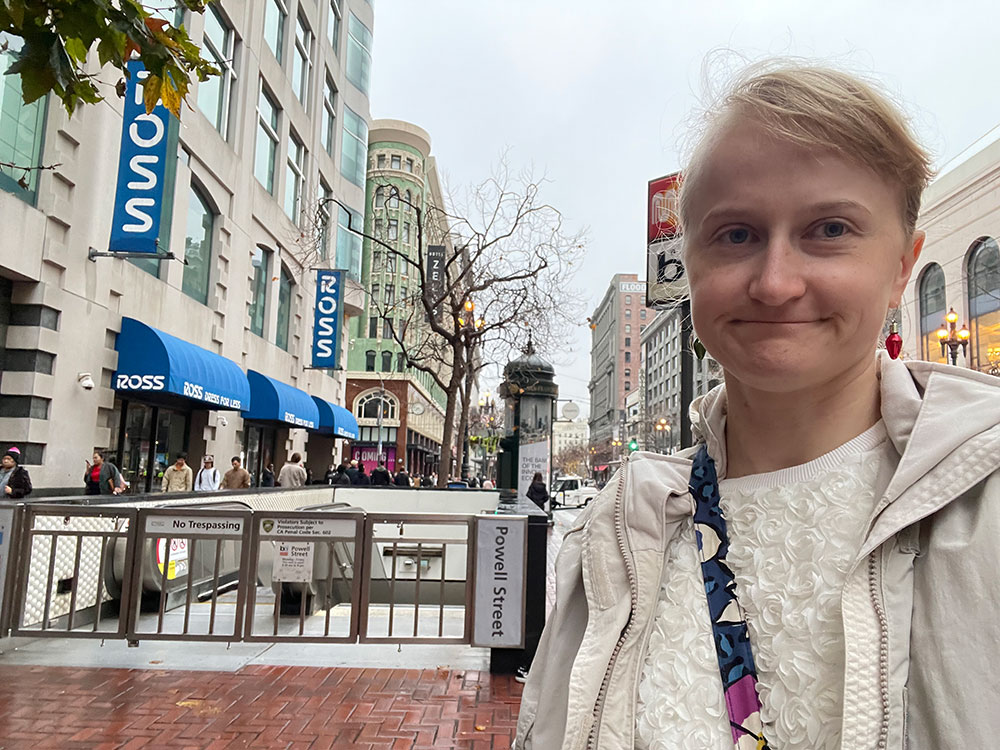 Veronica standing next to a closed Powell BART station.