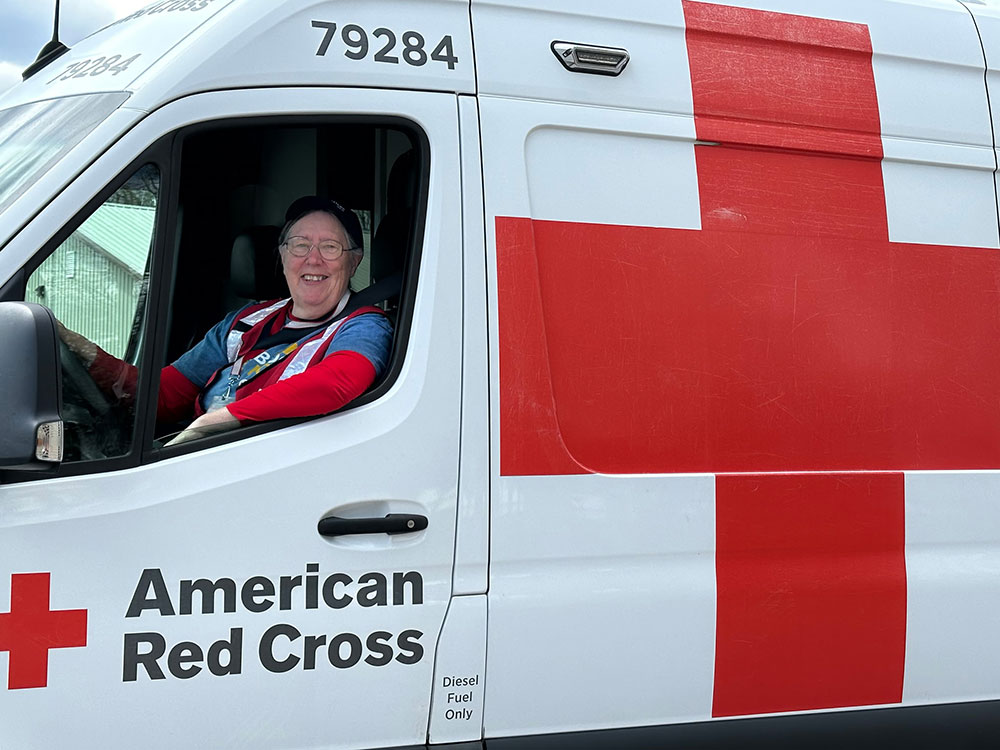 Red Cross disaster volunteer Susan Reese driving a Red Cross Emergency Response Vehicle.