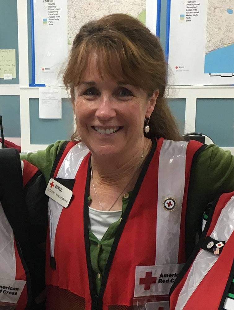 Susanne Newswanger in Red Cross vest smiling for camera