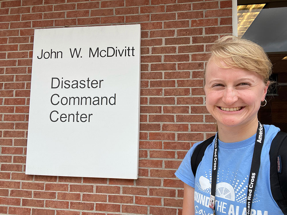 Veronica Oberholzer smiling in front of John W. McDivitt Disaster Command Center.