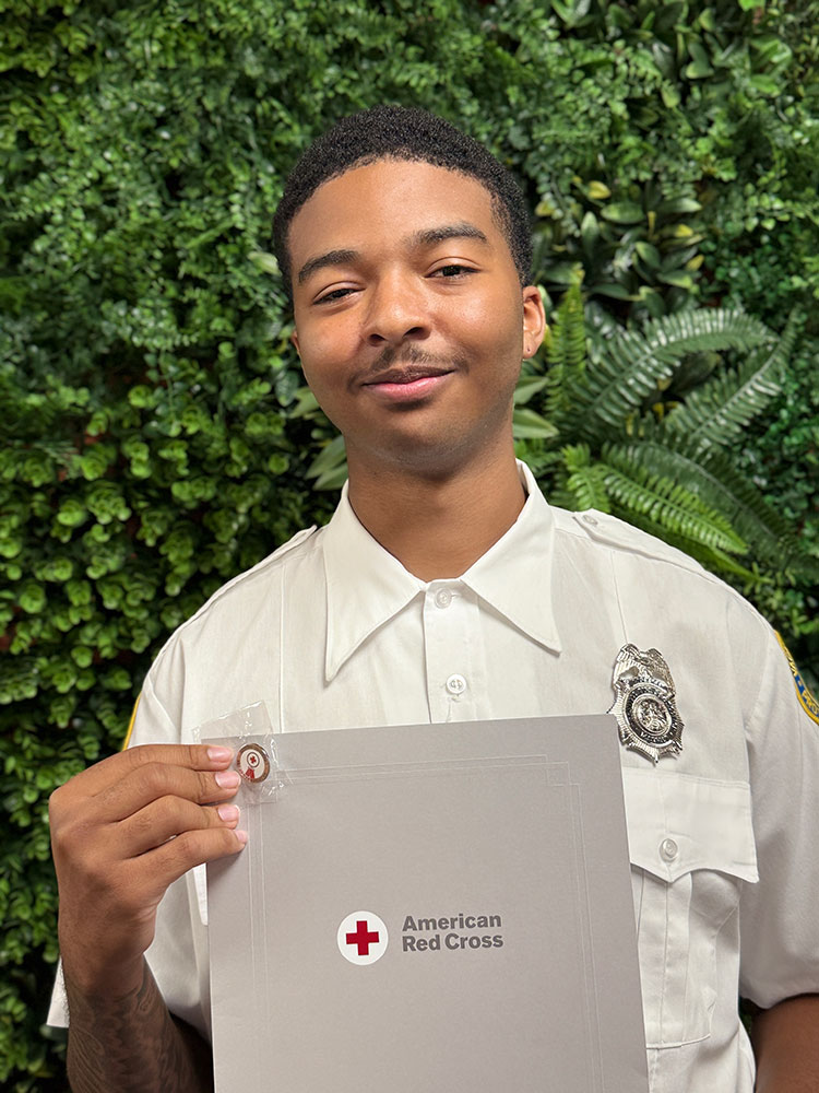 Vincent Hayes holding his Certificate of Extraordinary Personal Action.