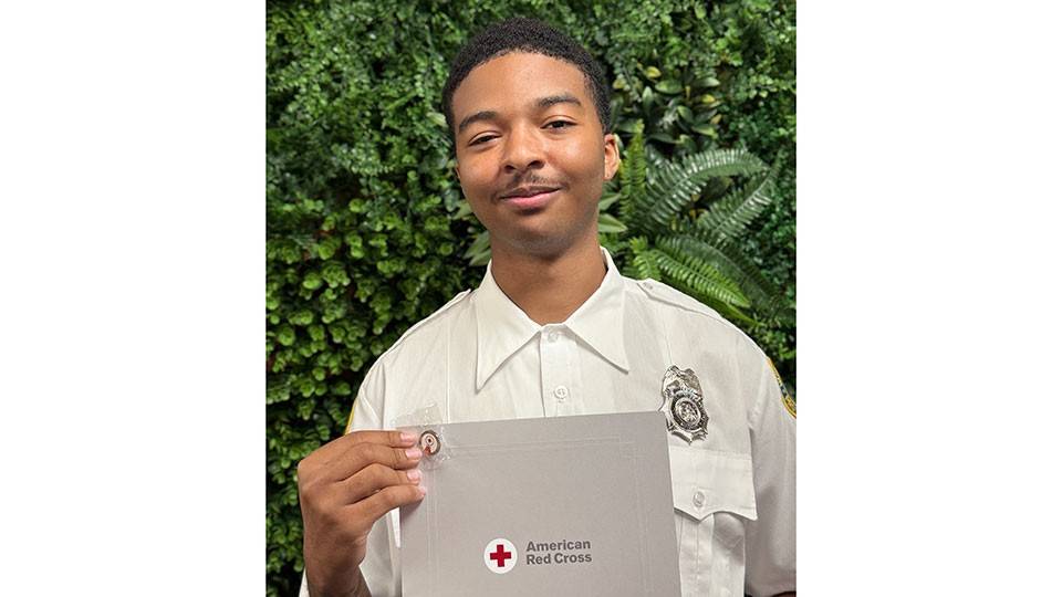 Vincent Hayes holding his Certificate of Extraordinary Personal Action.