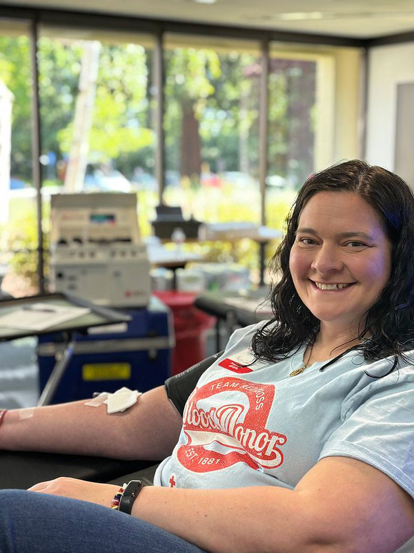 Anna-mary Geist sitting in cot donating blood.