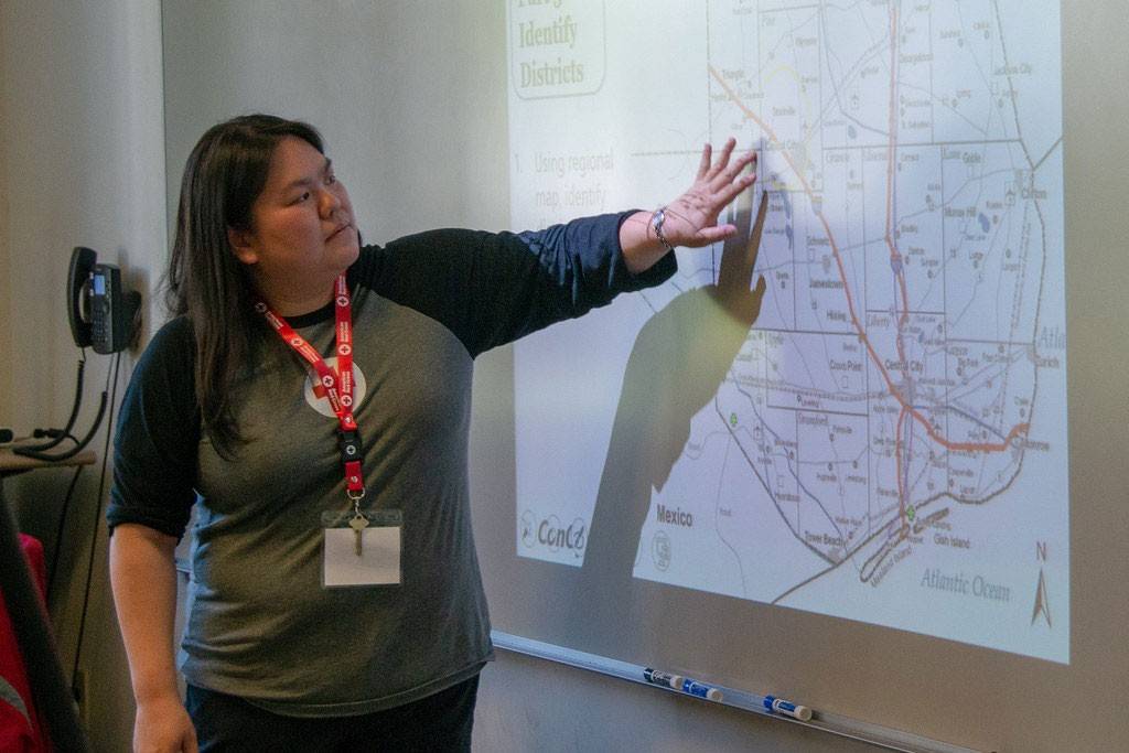 Debbie Yee pointing at map projeted on wall