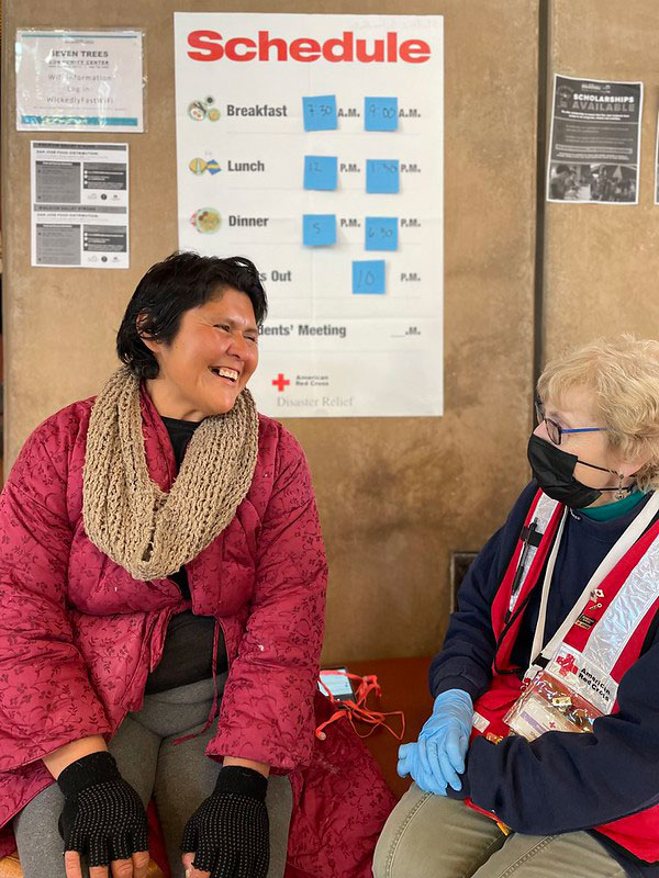 A Red Cross disaster mental health volunteer talks with a shelter resident.