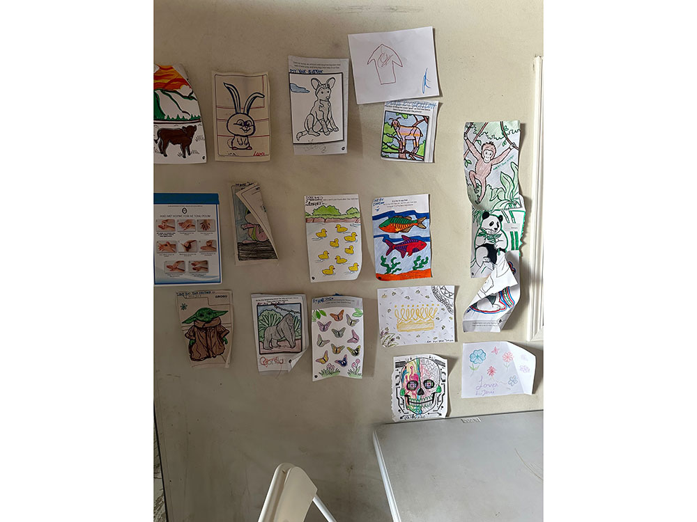 Drawings that have been colored in hanging on a wall