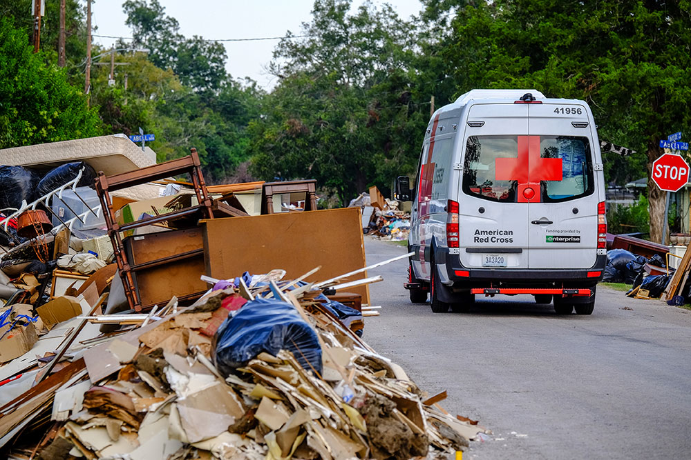 A Red Cross van next to debris on the side of the road left in the wake of Hurricane Harvey.