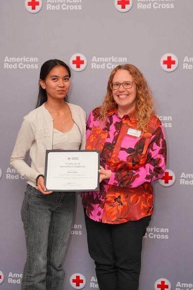 Red Cross intern Keira Indick receiving her internship completion certificate.