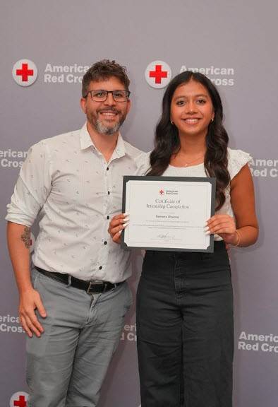 Red Cross intern Sameira Sharma receiving her internship completion certificate.