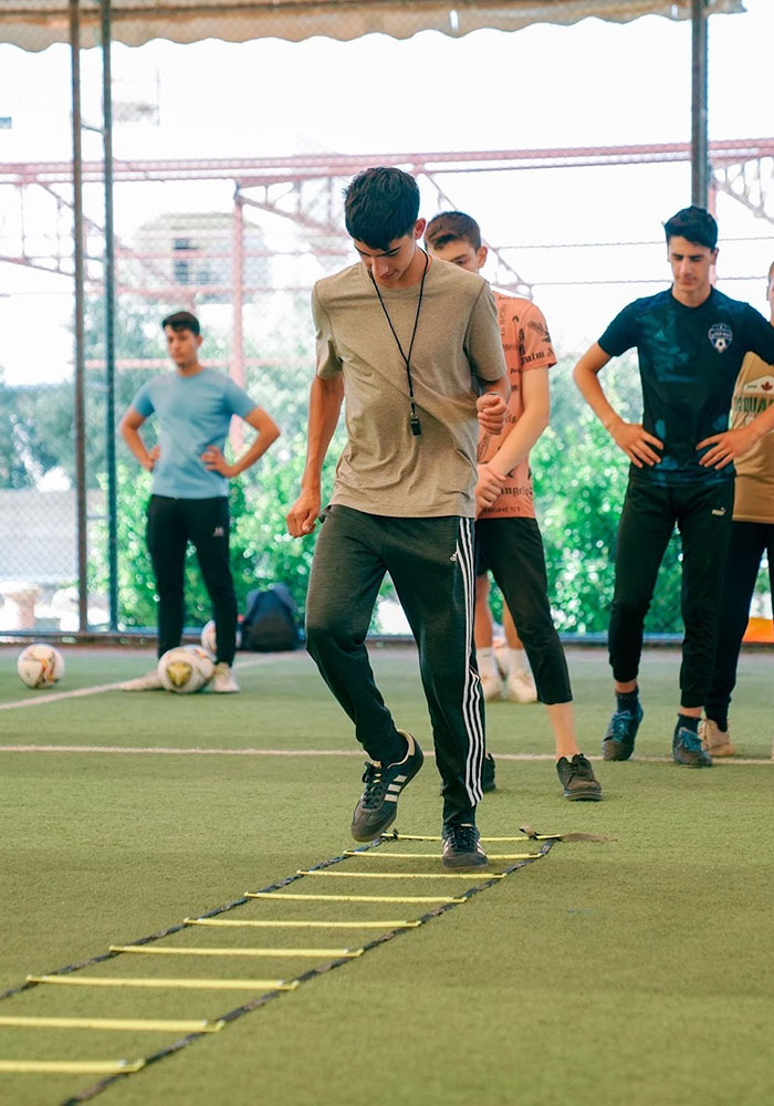 Malik practicing drills at the Youth Soccer Camp for Karam House.
