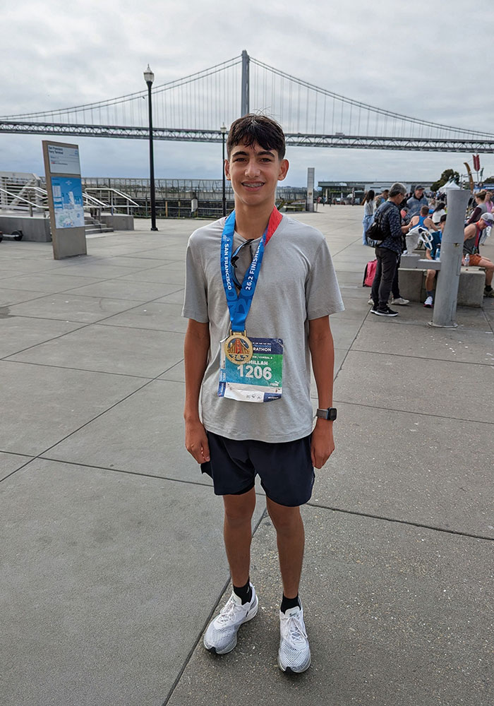 Malik, wearing a medal around his neck, after his marathon run to raise funds for the Karam Foundation.