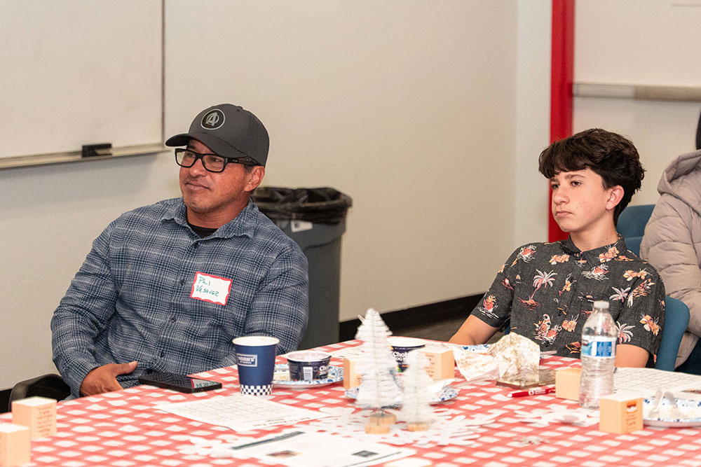 Phillip sitting at a table with his son Andrew at the Lifesaving Award ceremony.