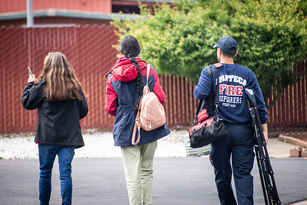 Red Cross volunteers walking to houses to install smoke alarrms.