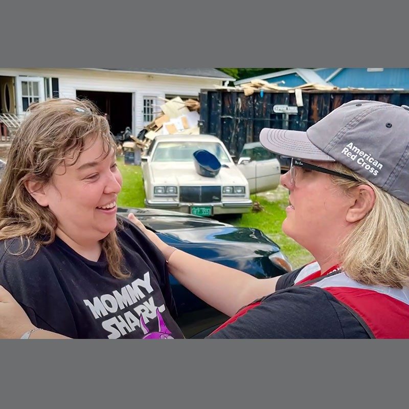 Red Cross volunteer comforting lady