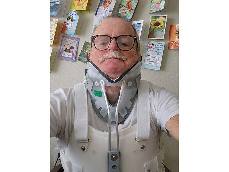 Mark Munson with body brace taking selfie