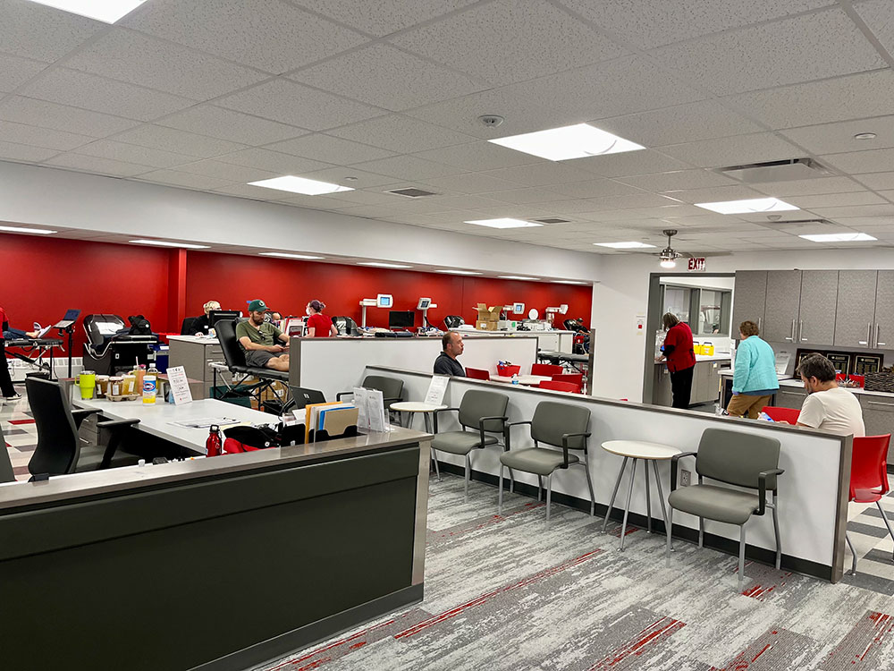 inside the newly renovated Red Cross facility in Portland, with chairs and desks and people walking around.
