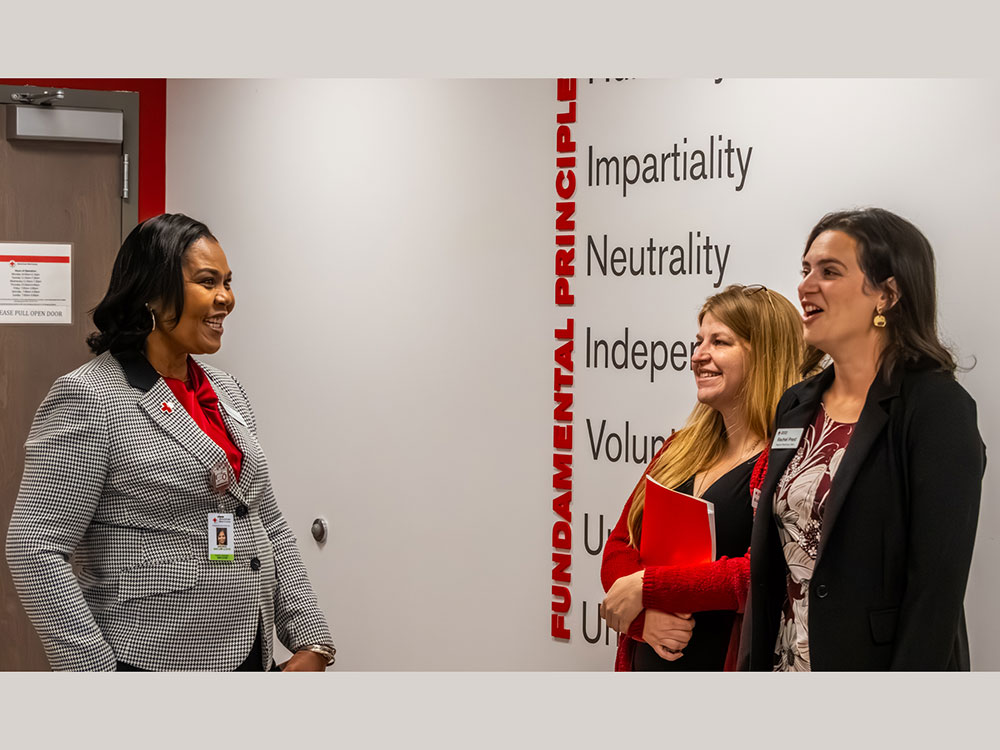 three people talking to each other the newly renovated Red Cross facility in Portland.