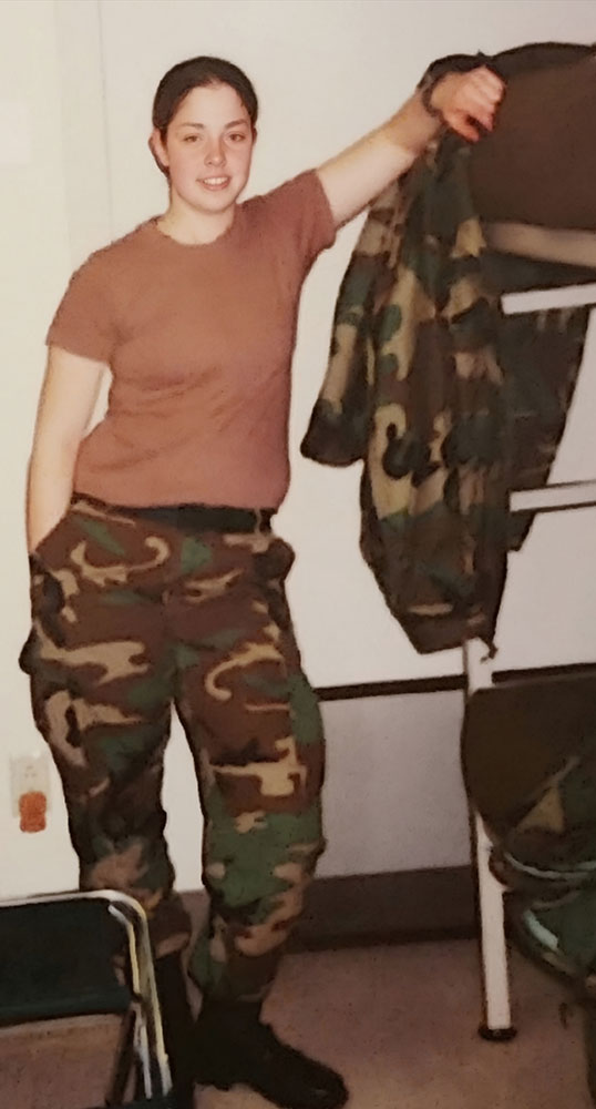 Ashley St. Louis wearing Army Combat pants with jacket hanging on bunk bed.