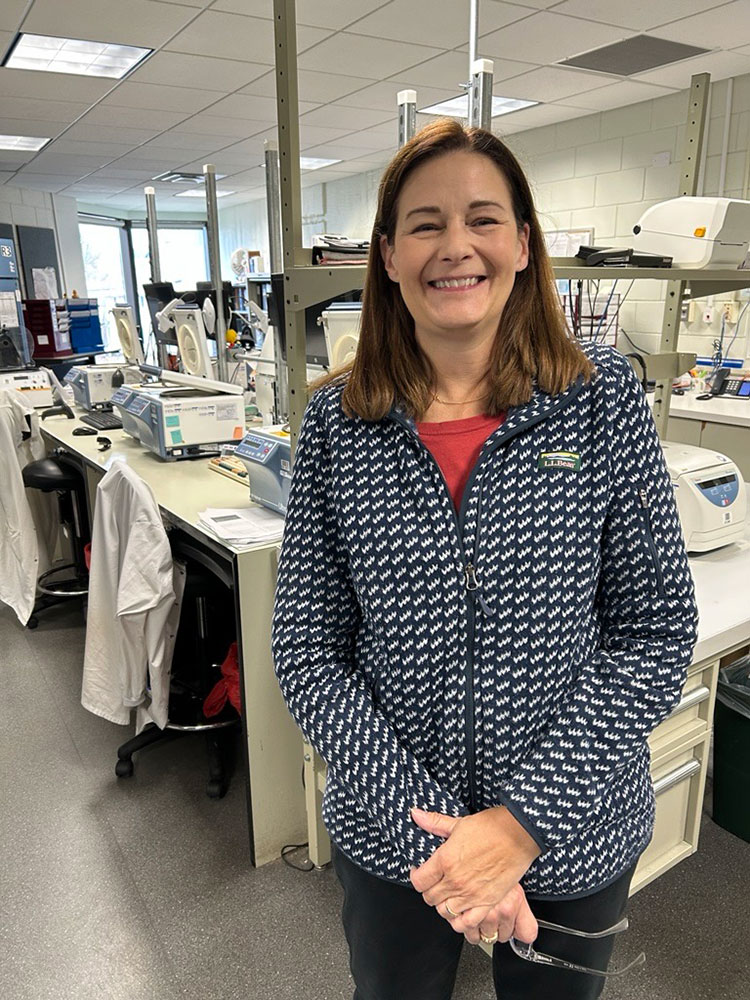 Beth Champney in a lab smiling for picture.