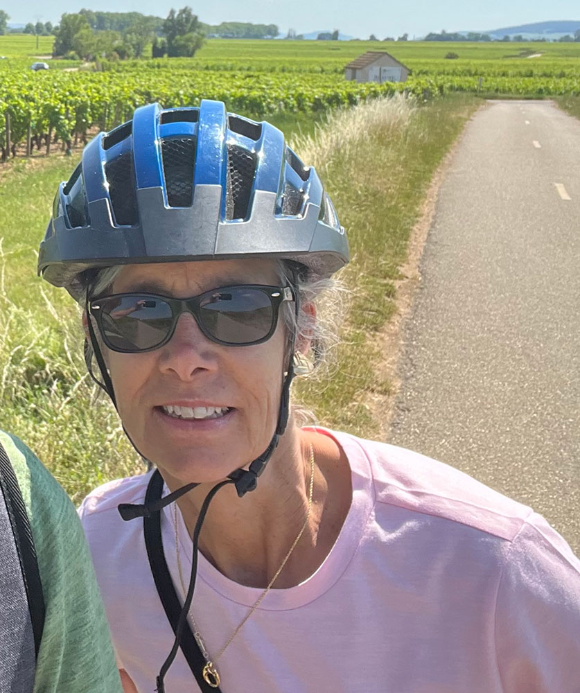 Brenda Foley wearing a bike helmet and sunglasses.