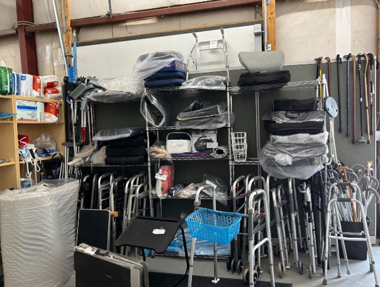 Multiple canes and walkers in a storage room.