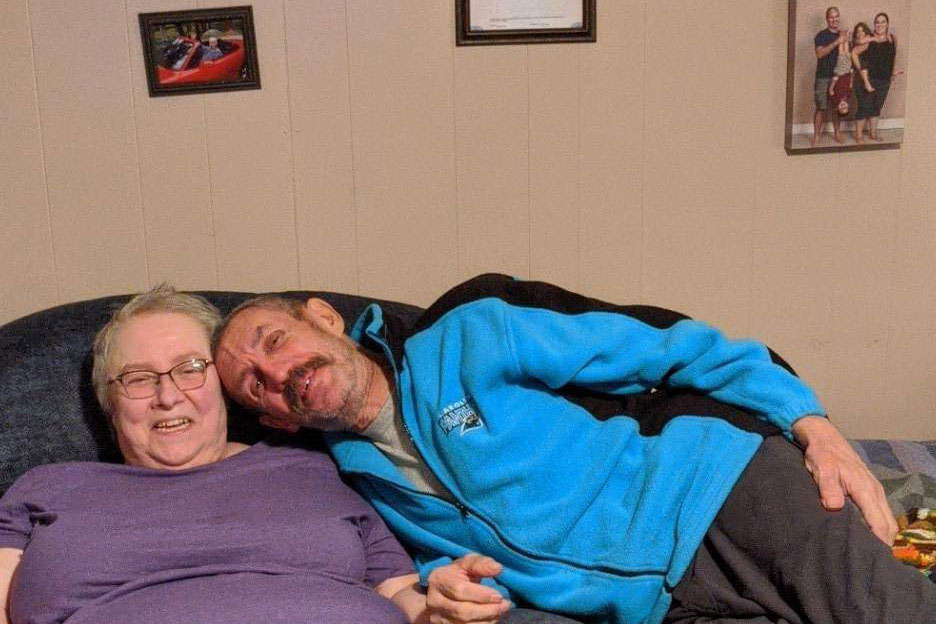 Diana and Gary Levesque sitting on a couch.