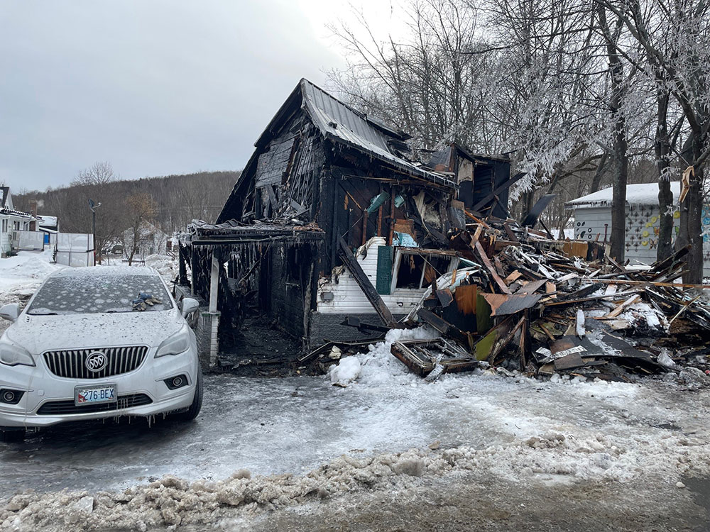 burned down house in the snow.