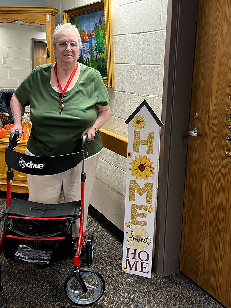 Diana Levesque standing with a walker.