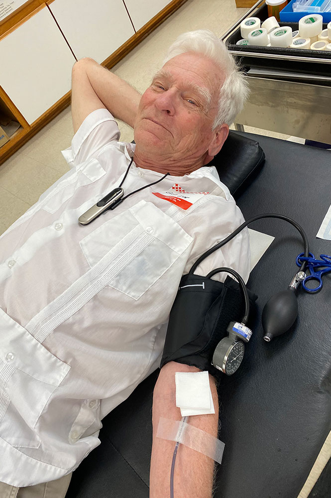 Gary Schilmoeller donating blood at a blood donation center.
