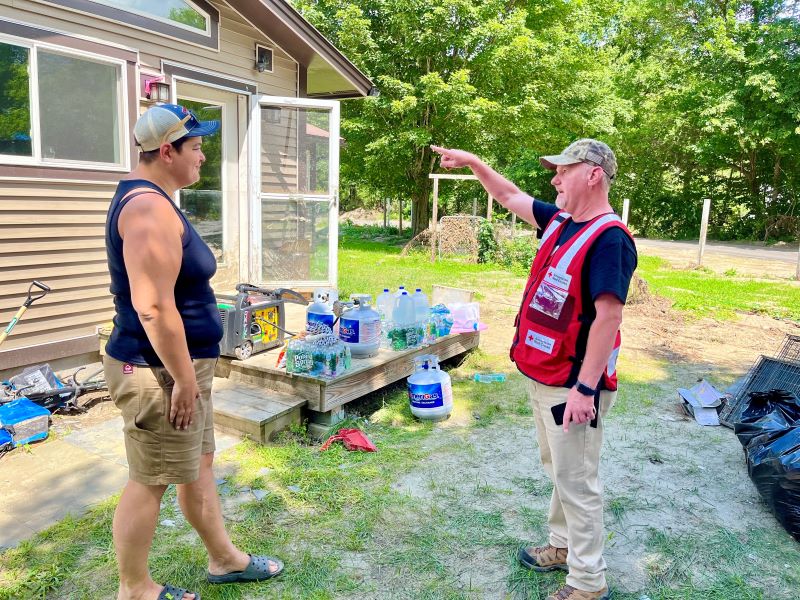 A person pointing out a home to another person
