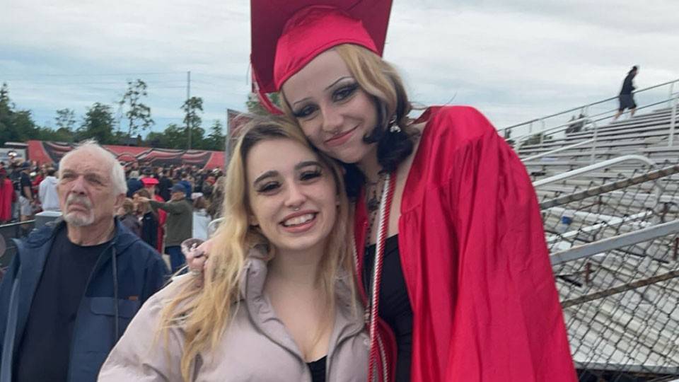 Jade and Mandy Howard hugging each other at a graduation.