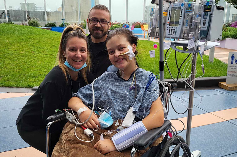 Lilly Chamber in wheel chair with parents