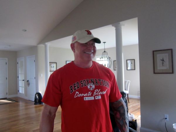 Phillip in red shirt smiling